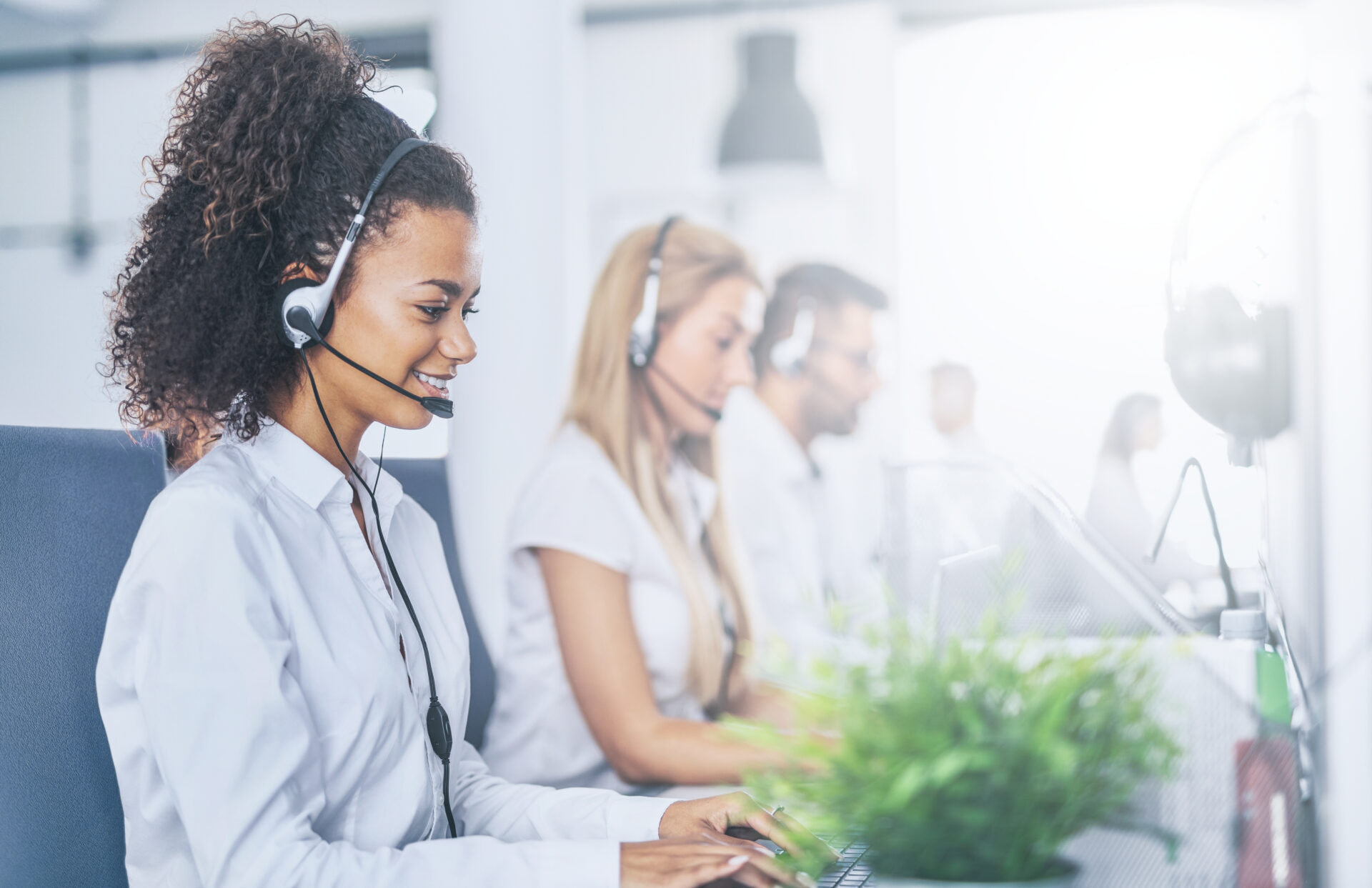 Call center worker with headset smiling